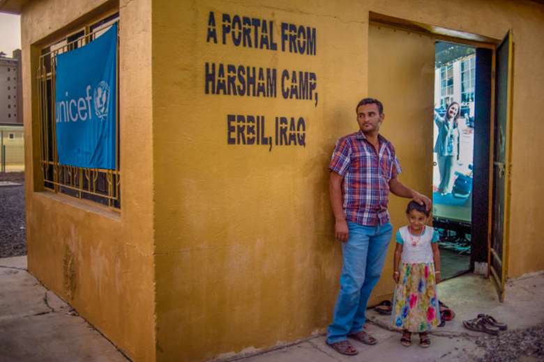 A father and daughter outside the portal at the Harsham Camp for Internally Displaced Persons in Erbil, Iraq 