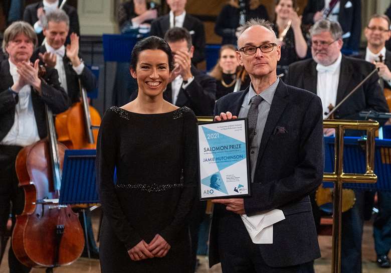 Jamie Hutchinson (left) receives her Salomon Prize from ABO chief executive Mark Pemberton (right)
