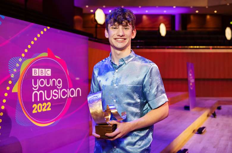 Percussionist Joran Ashman holds his BBC Young Musician 2022 truophy, following the competition grand final held at Manchester's Birdgewater Hall © Dan Prince/BBC