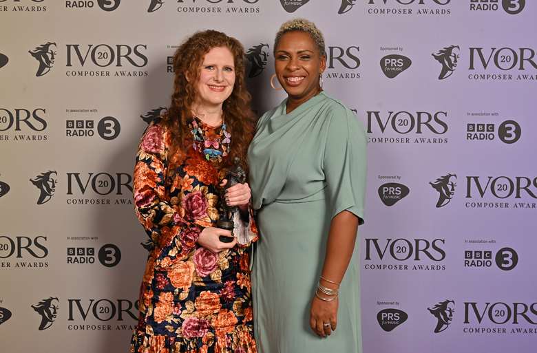 Cheryl Frances-Hoad accepts the Ivor Novello Award for Large Ensemble from songwriter Michelle Escoffery © Mark Allan Photography