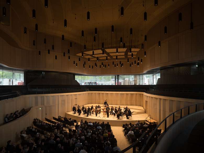 The venue's curved, light wood, gives audiences the sense of being sat inside a top-of-the-range, high-definition speaker © Marcus Ebener