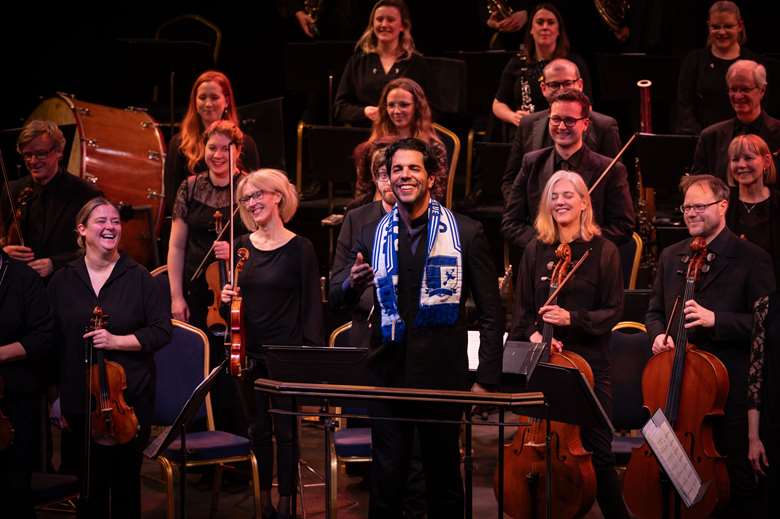 Putting down roots: RLPO chief conductor Domingo Hindoyan closes the orchestra's first concert of it new residency draped in a Barrow AFC scarf © Clare Stevens