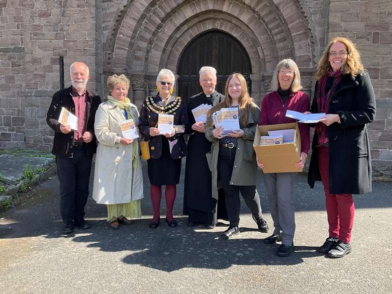 Leominster Priory director of music and priory 900 co-ordinator Hilary Norris (right) with the Priory Arts team outside the Norman west door of the Priory (Image courtesy of Priory Arts)